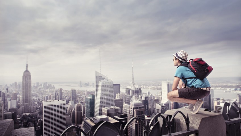 Tourist kneeling on the rooftop